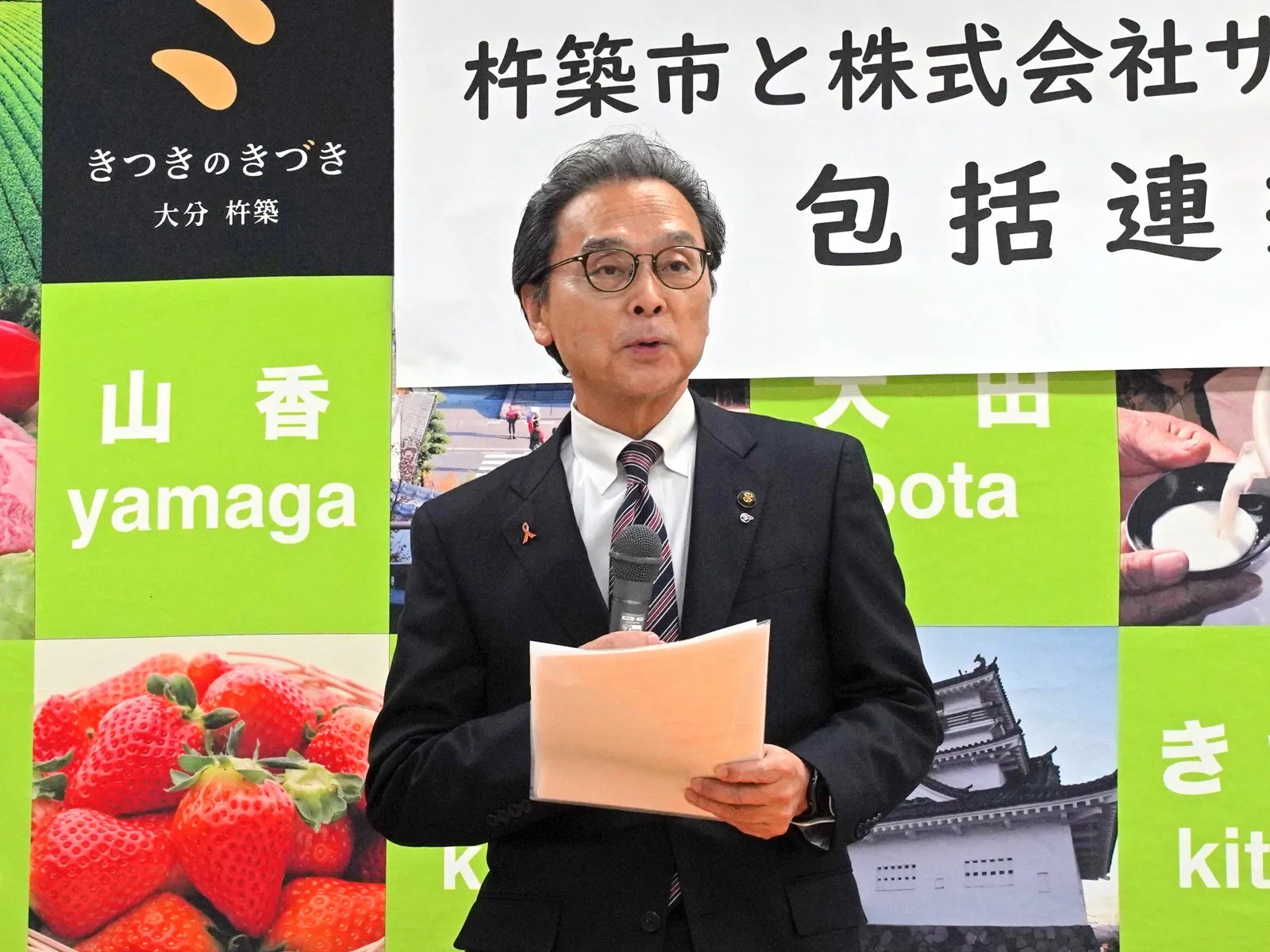 記者会見でスピーチをする男性