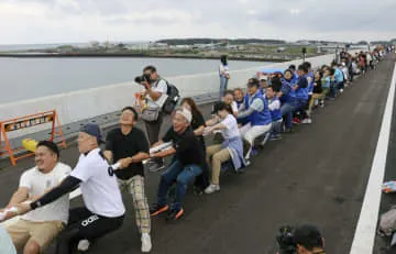 2県結ぶ新たな橋上で綱引き